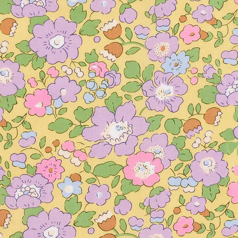 Floral pattern with purple, pink, and green flowers on a yellow background