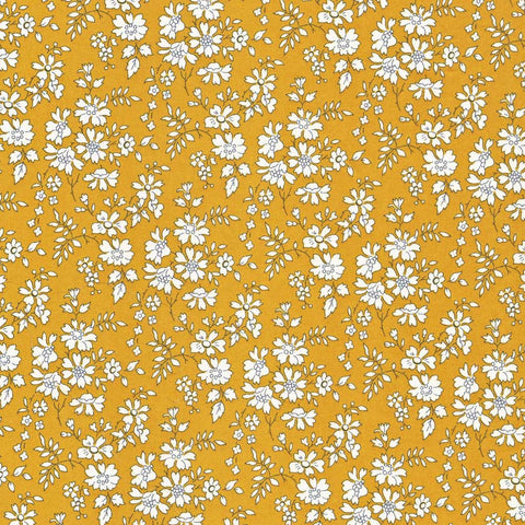 White floral pattern on a mustard yellow background