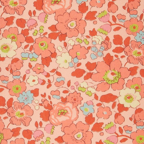 Floral pattern with pink, red, and blue flowers on a pink background
