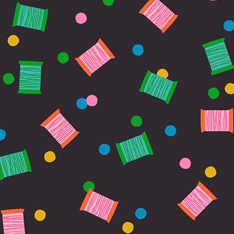 Colorful thread spools and polka dots pattern on a black background 