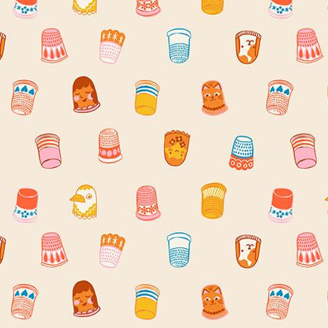 Patterned fabric with colorful thimbles and sewing-related designs on a beige background