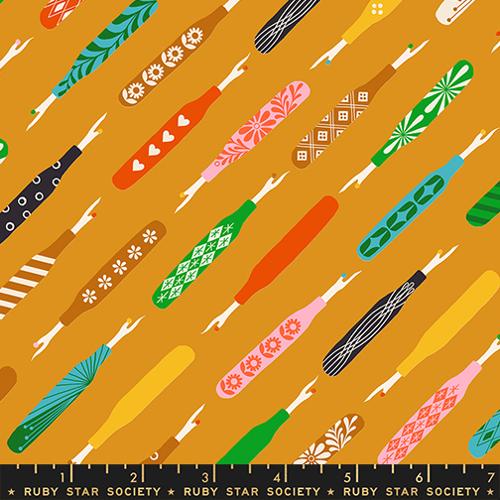 Pattern of colorful fabric swatches with various designs on a mustard yellow background, featuring the Ruby Star Society logo.