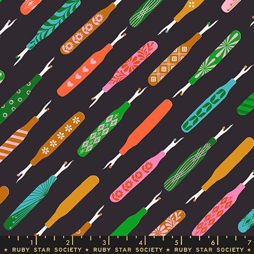 Colorful pattern of fabric swatches with a ruler at the bottom on a black background, featuring designs by Ruby Star Society.