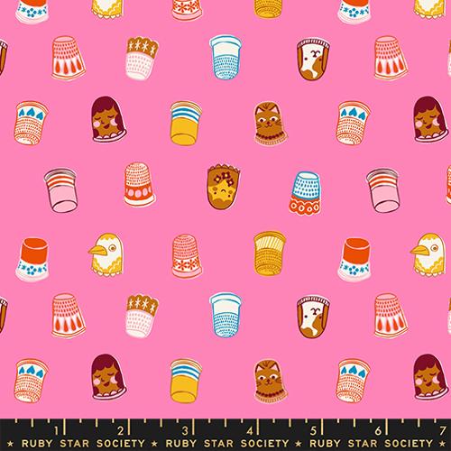 Patterned fabric with cartoon-style thimbles and小姑娘 on a pink background, featuring a ruler at the bottom.