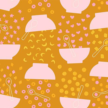 Patterned fabric with pink bowls and spoons on a mustard background,