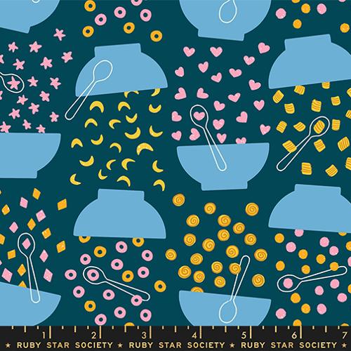 Patterned fabric with blue bowls, spoons, and colorful shapes on a dark blue background.
