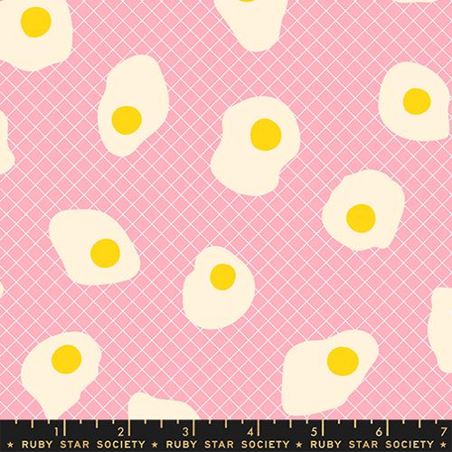 Pattern of white eggs with yellow yolks on a pink background with a grid, featuring Ruby Star Society label.