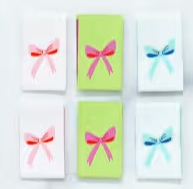 Set of colourful labels with pink and blue bows on a white background