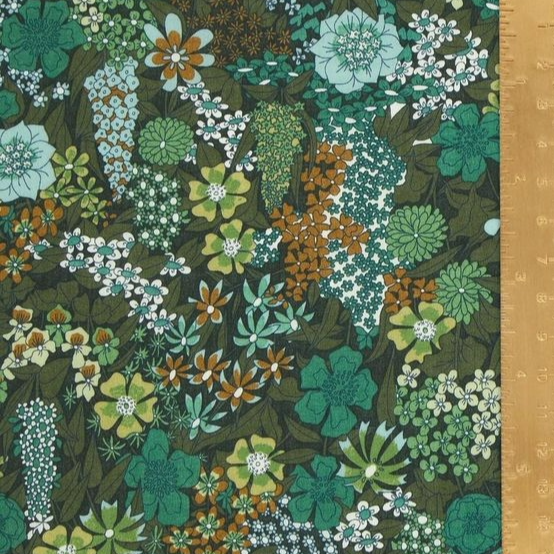 Floral fabric pattern with green, brown, and white colors on a dark background.