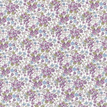A repeating floral pattern featuring small purple and blue flowers with green leaves on a white background.