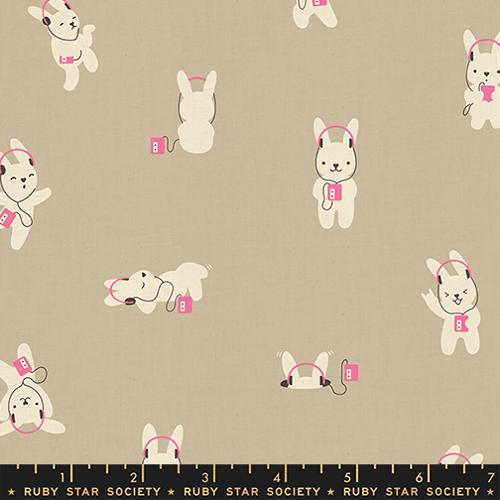 Fabric with cartoon dogs wearing headphones on a beige background, featuring Ruby Star Society label.