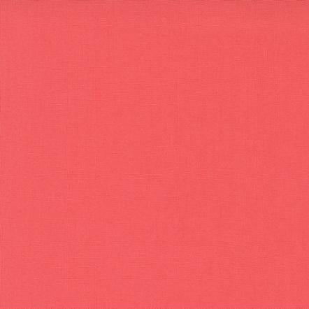 Solid coral fabric swatch with a ruler at the bottom for scale.