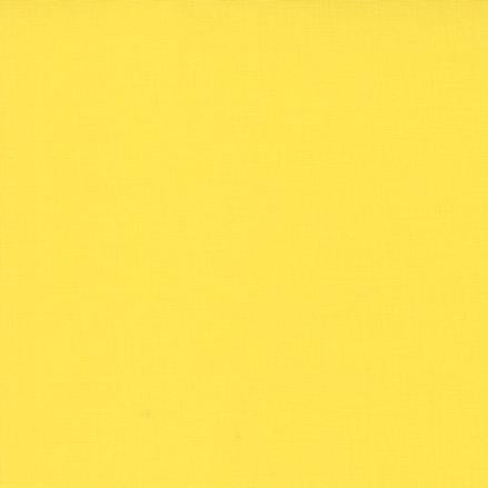 Solid yellow fabric swatch with a ruler at the bottom for scale.