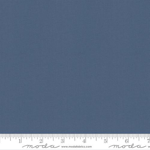 Solid blue fabric swatch with a ruler at the bottom for scale.