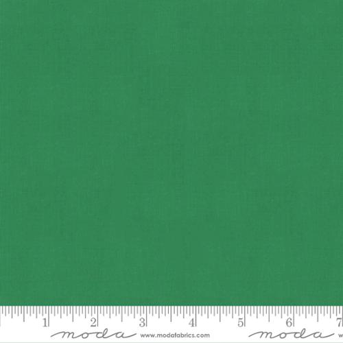 Solid green fabric swatch with a ruler at the bottom for scale.