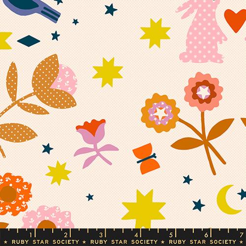Colorful fabric pattern with flowers, stars, and a ruler for scale on a beige background.