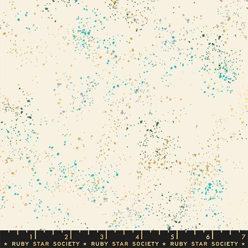 A fabric pattern swatch featuring a cream-colored background with scattered teal, gold, and dark green speckles, with a black ruler at the bottom displaying 'RUBY STAR SOCIETY' and measurement markings.