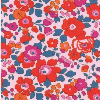 Floral fabric pattern with red, pink, and orange flowers on a pink background
