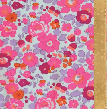 Floral pattern fabric with pink and orange flowers on a light blue background