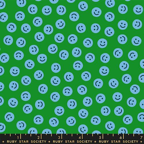 Pattern of blue smiley faces on a green background with Ruby Star Society label.