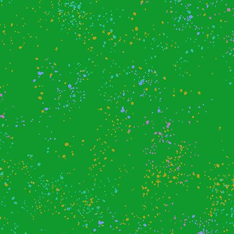 Green fabric with colorful speckles and a ruler at the bottom