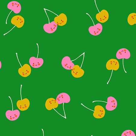 Pattern of colorful cherries on a green background 
