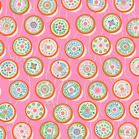 Fabric with circular patterns and text on a pink background