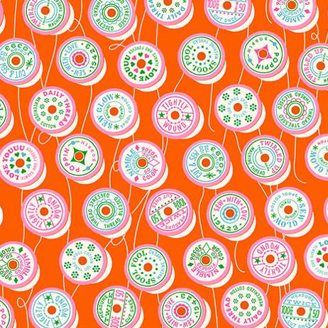 Fabric with colorful spool pattern on an orange background