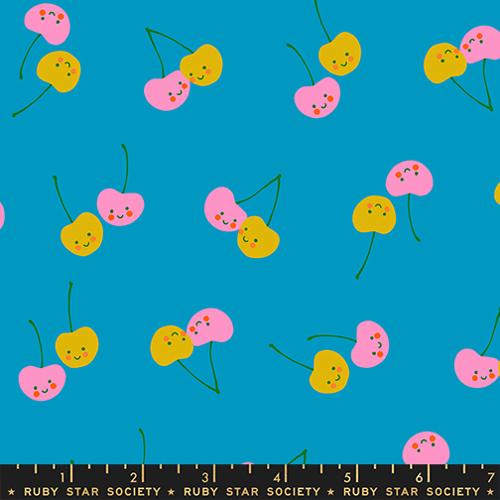 Pattern of colorful cherries on a blue background with a ruler at the bottom.