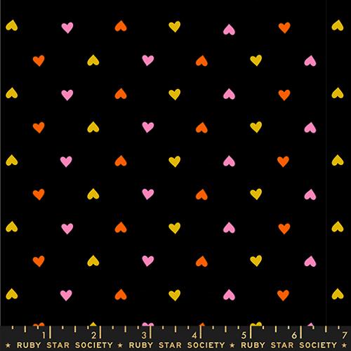 Pattern of colorful hearts on a black background with Ruby Star Society label.
