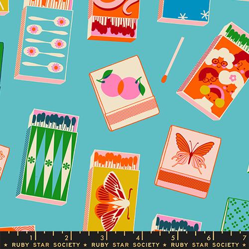 Patterned fabric with colorful matchbox designs on a blue background, featuring Ruby Star Society branding.