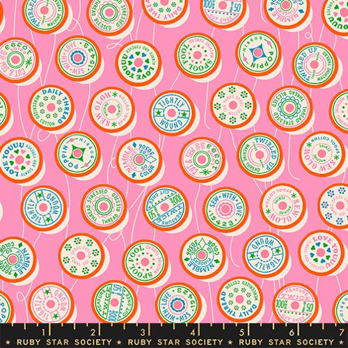 Fabric with circular patterns and text on a pink background, featuring the Ruby Star Society label.
