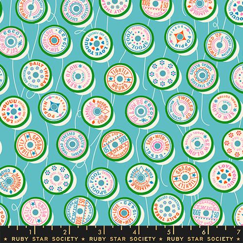 Patterned fabric with colorful circles on a blue background, featuring the Ruby Star Society label.