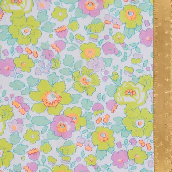 Floral patterned fabric with a ruler for scale on a light blue background