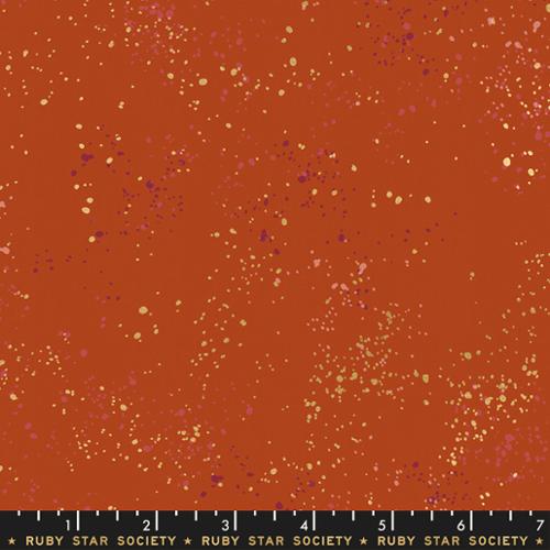 Fabric with speckled pattern on a red background, featuring 'Ruby Star Society' label.