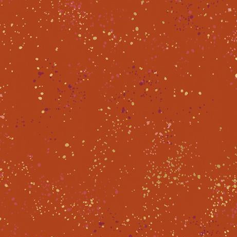 Fabric with speckled pattern on a red background